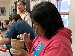 Female student working on a pottery activity