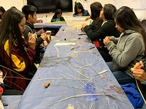 Students using hay as part of a classroom activity